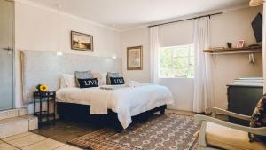 a bedroom with a bed and a window at Yellow House Prince Albert in Prince Albert