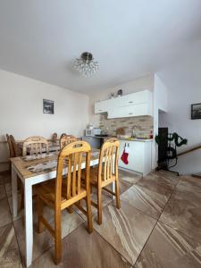 a kitchen and dining room with a table and chairs at Pokoje "U Ani" in Leśnica