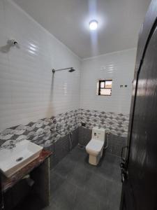a bathroom with a toilet and a sink at hotel ramdev in Arambol