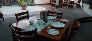 a wooden table with plates and napkins on it at bansri villa in Mount Lavinia