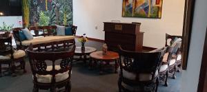 a room with chairs and a table and a couch at bansri villa in Mount Lavinia