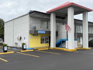 a building with an american flag in a parking lot at Englewood Inn & Suites in Englewood