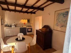 a kitchen and dining room with a table and chairs at Luce su Civita in Lubriano