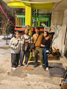 a group of people standing in front of a building at Parbati Headquarters in Kasol