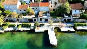 an aerial view of a house with a dock in the water at BASTADUR rooms in Kotor