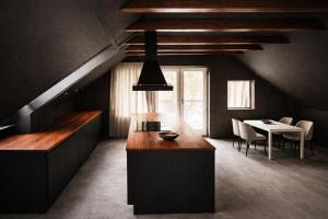 a kitchen with a table and a dining room at FourSeasons - Carnival Summer Lounge in Aalborg