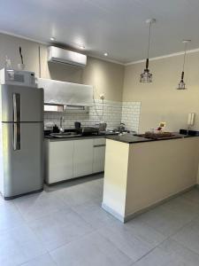 a kitchen with a refrigerator and a counter top at La quinta de Vito in San Pedro
