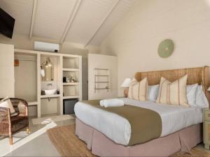 a bedroom with a large bed in a room at Arc Guest House in Simonʼs Town