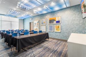 a conference room with tables and blue chairs at Holiday Inn Express & Suites - Houston NW - Cypress Grand Pky by IHG in Cypress +54 photos