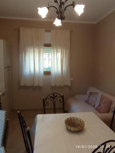 a room with a table and a bed and a window at Casa Tella in Pula