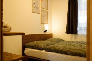 a bedroom with a bed and a lamp on the wall at Apartment Horalka - Jasná in Belá