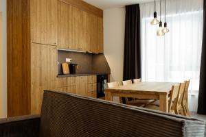 a dining room with a wooden table and chairs at Apartment Horalka - Jasná in Belá