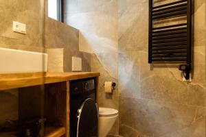 a bathroom with a toilet and a sink at Apartment Horalka - Jasná in Belá +10 photos