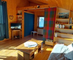 a living room with a couch and a table at Mini chalet dans le Mercantour in Colmars