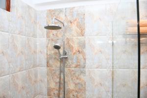 a shower with a shower head in a bathroom at Hotel Lanka Super Corals in Hikkaduwa +52 photos