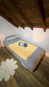 a bed with a tool on top of it at Casinha do Rosa in Imbituba