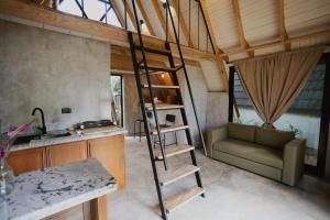 a room with a ladder and a couch in a kitchen at Casa Cayena - Hibiscus House in El Valle