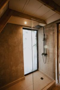 a shower in a room with a glass door at Casa Cayena - Hibiscus House in El Valle