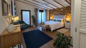 a bedroom with a king sized bed and a couch at Casa de Olivos - Unique Apartments - Adult Only in Traiguera +117 photos