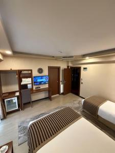 a hotel room with a bed and a television at My Liva Hotel in Kayseri +25 photos