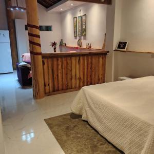 a bedroom with a tub and a sink and a bed at Chácara Sitara - Chalé Safira in Caldas