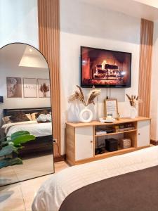 a bedroom with a bed and a tv on a wall at Casa Del Sol in Manila +19 photos