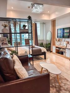 a living room with a couch and a table at Casa Del Sol in Manila