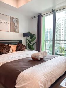 a bedroom with two beds and a large window at Casa Del Sol in Manila