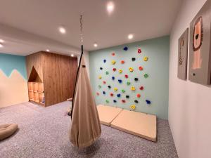 a kids room with a rock wall and a hammock at Cyrhla Apartamenty - sauna, playroom, free parking & wifi in Zakopane +291 photos
