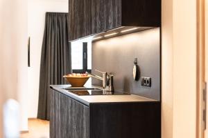 a kitchen with a sink and a bowl of fruit at Senner Nature Stay in Riscone +37 photos