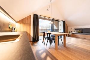 a kitchen and dining room with a table and chairs at Senner Nature Stay in Riscone