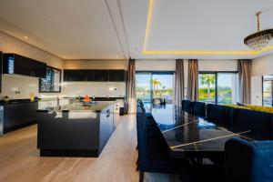 a kitchen and living room with a table and a couch at Villa Dar E'Zwinna in Marrakesh