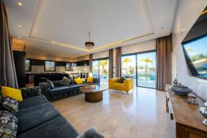a living room with a couch and a table at Villa Dar E'Zwinna in Marrakesh
