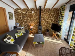 a living room with a stone wall at Casa de Olivos - Unique Apartments - Adult Only in Traiguera
