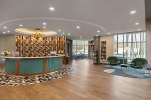 a lobby with a reception desk and chairs at Hotel Indigo Columbus Architectural Center by IHG in Columbus +58 photos