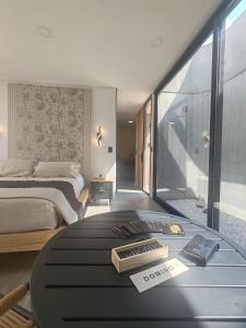 a bedroom with a bed and a table with books on it at Riviera Mendoza in Las Compuertas
