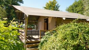 a tent in the middle of a garden at Camping d'artagnan in Margouët-Meymès