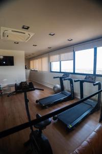 a gym with several treadmills in a room at Flat exclusivo Studio Cuiabá 1207 in Cuiabá