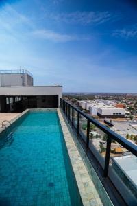 a swimming pool on the roof of a building at Flat exclusivo Studio Cuiabá 1207 in Cuiabá