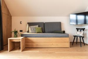 a bed in the corner of a room at Senner Nature Stay in Riscone