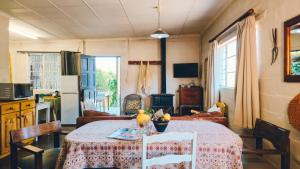 a dining room with a table and a kitchen at Yellow House Prince Albert in Prince Albert