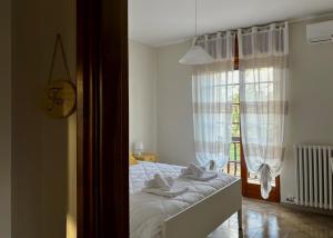 a bedroom with a bed with white sheets and a window at Terrarossa in Crispiano +19 photos