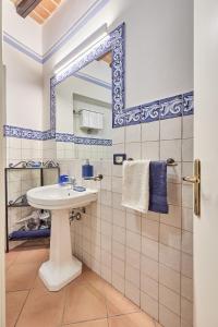 a bathroom with a sink and a mirror at Vicolo Nobile in Montepulciano +23 photos