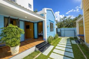 a home with a blue and white house at An Phú Villa in Cu Lao Thu