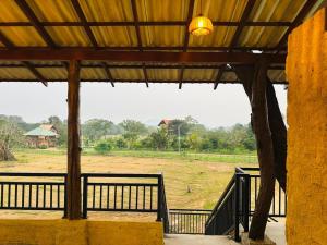 a view of a field from the inside of a building at Green Heaven Sigiriya in Sigiriya
