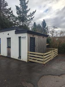 a small shed with a wooden fence around it at Viewpoint Pods in Dunollie