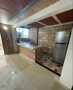 a kitchen with a stainless steel refrigerator in a room at San ANTERO Cabaña Positano in San Antero