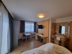 a hotel room with a bed and a bathroom at Haus Fernblick in Neustift im Stubaital