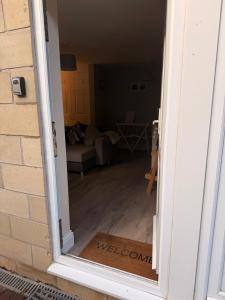an open door to a living room with a view at Cosy Flat, close to Bath Rugby and City Centre in Bath