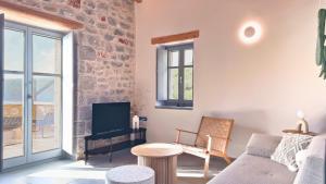 a living room with a couch and a table at Eleonas Limeni in Limeni